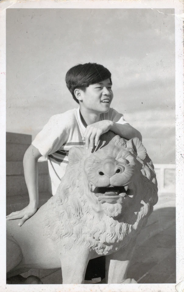 David beside a stone lion in Xiamen during his school years, 1957–1958. Identified and dated by Esther.