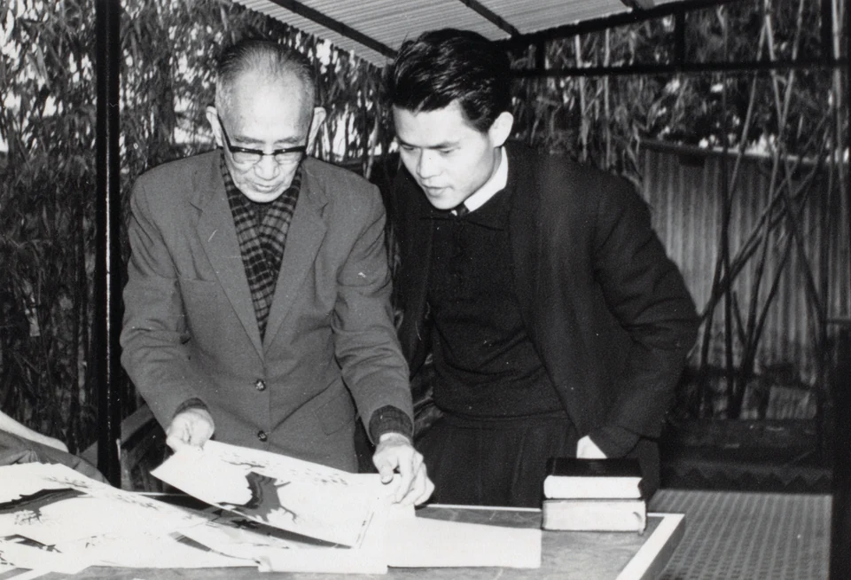 David with an artist in Hong Kong during his seminary years, about 1967–1971. Esther recalls that he was asked to prepare artwork for an event.