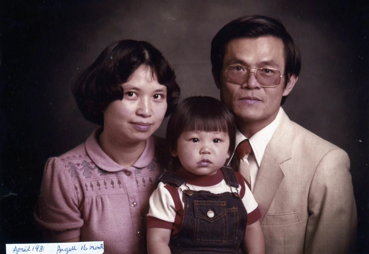 An archival studio portrait of two parents and their young child, with a handwritten April 1981 caption.