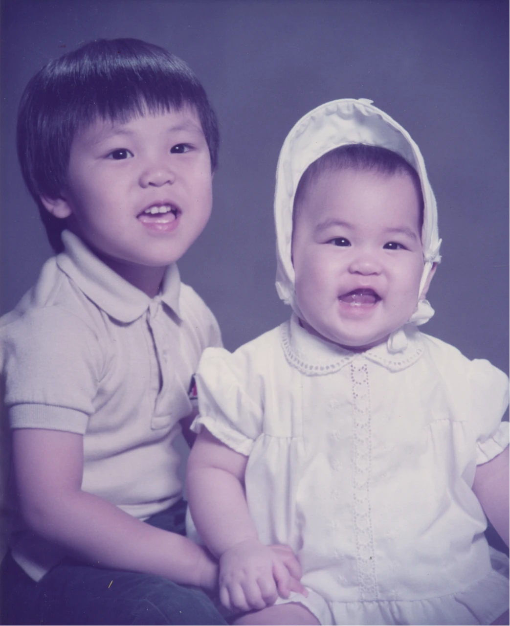 Baby Sunny in a white bonnet beside her older brother Angell.